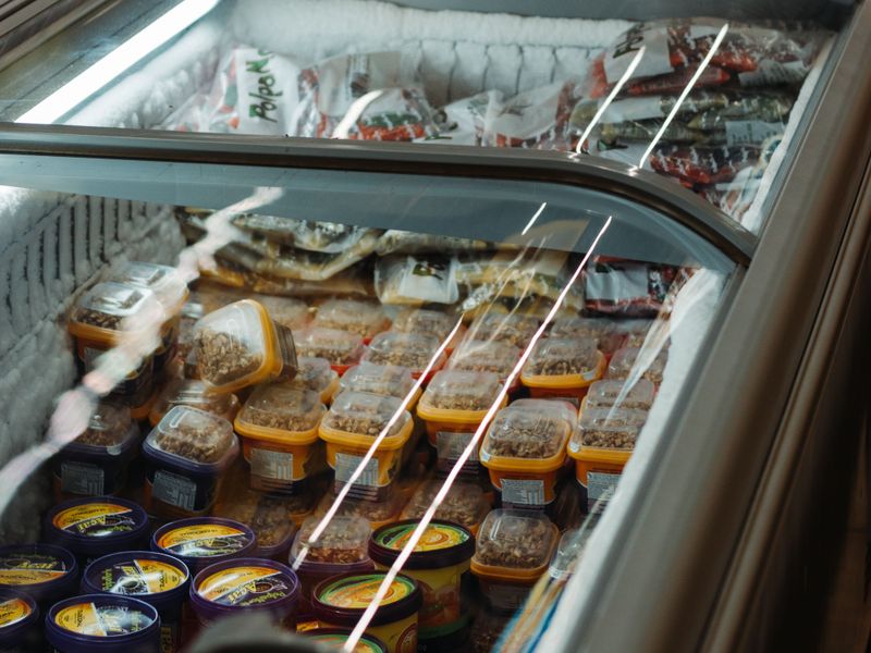 Commercial chest freezer stocked with packaged food products